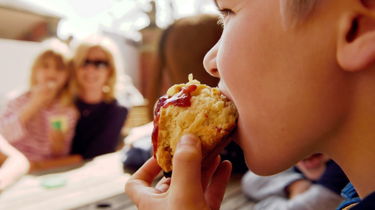Visitor enjoying a scone at a National Trust cafe